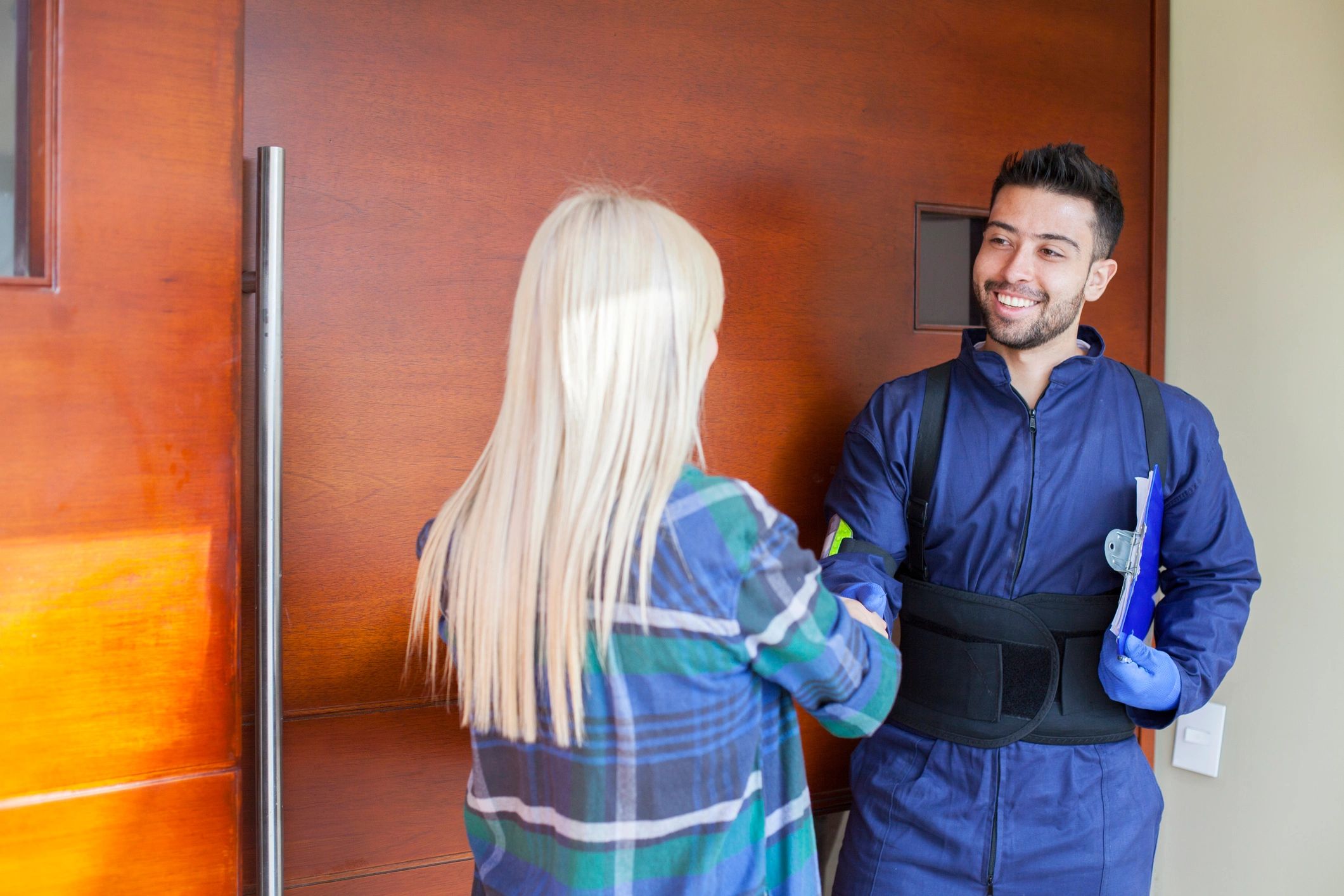 Homeowner greeting a service professional at the front door
