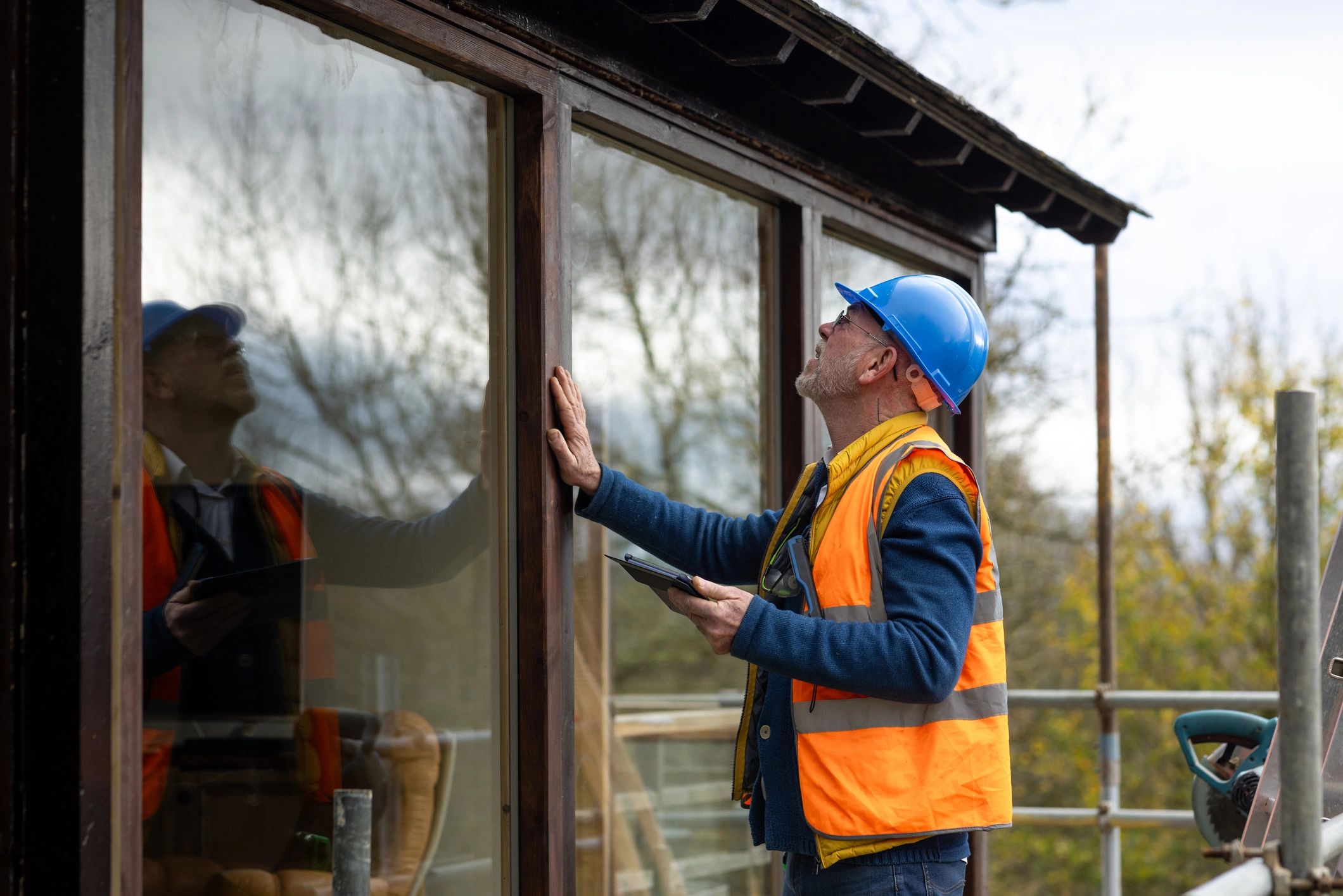 Field technician with clipboard performing an exterior property check