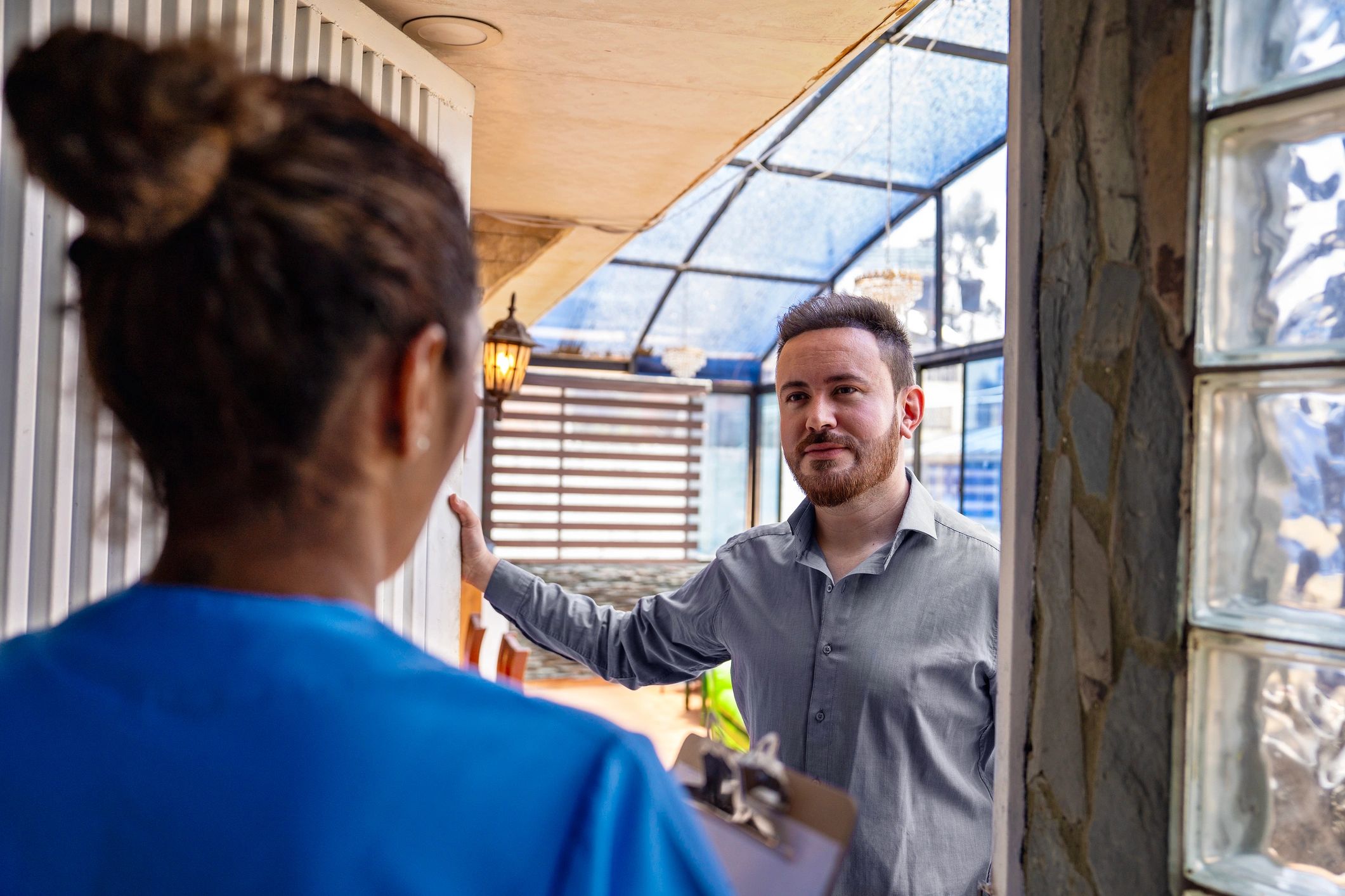 Service professional discussing next steps with a homeowner during a home visit